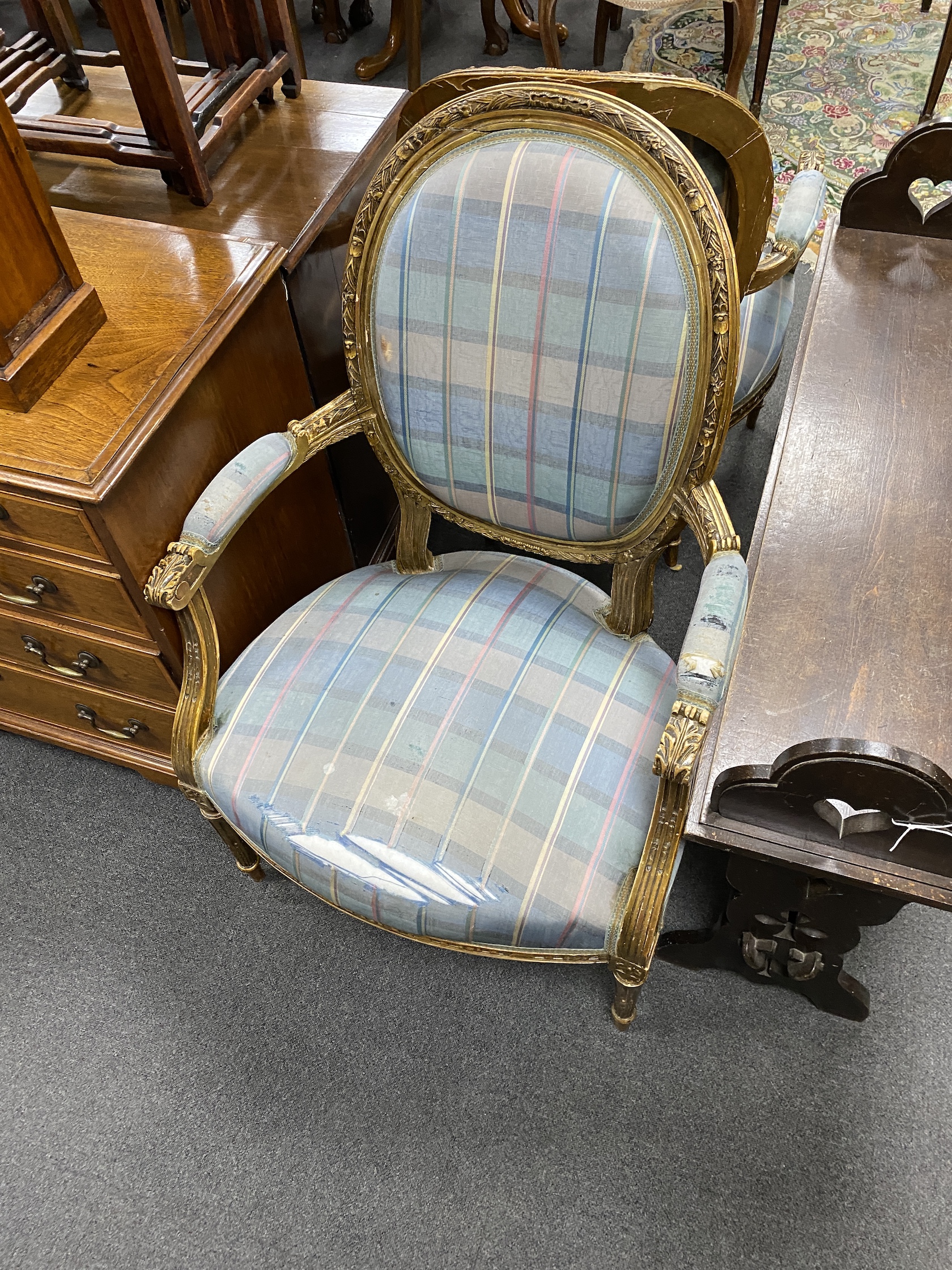 A set of four Louis XVI style giltwood and composition fauteuil, width 64cm, depth 54cm, height 107cm